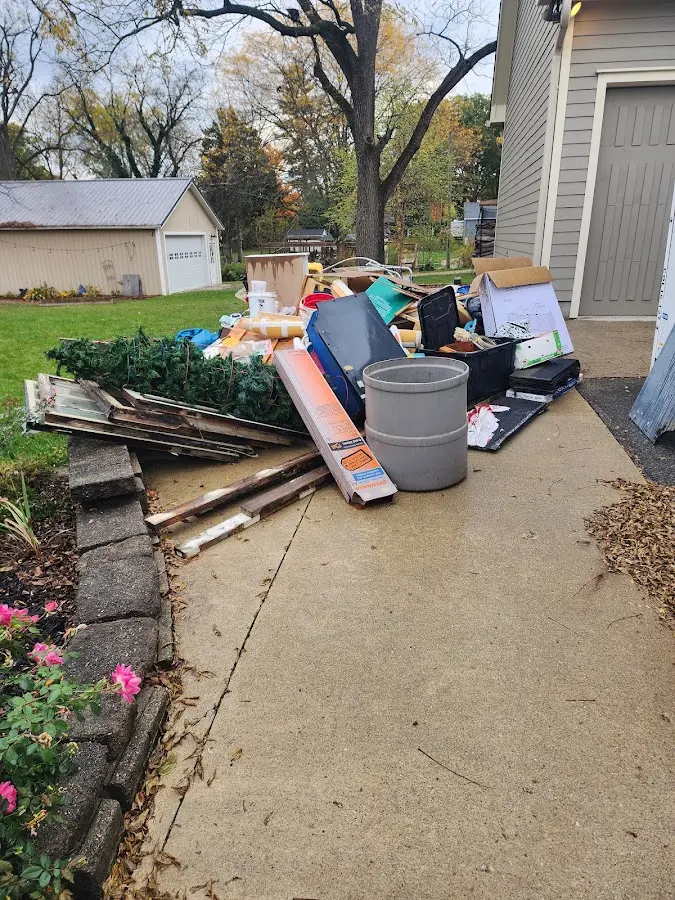 Dumpster being loaded with debris for Residential Dumpster Rental in Flint